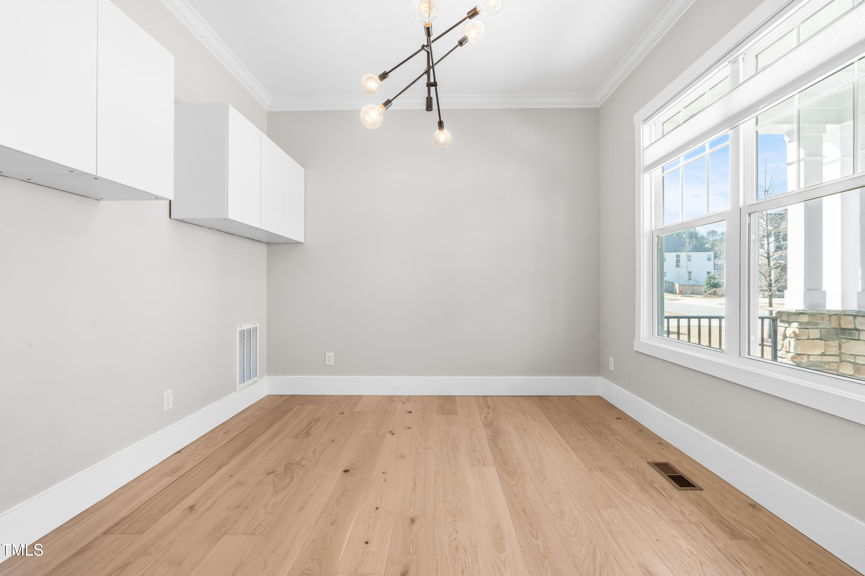 409 Tintern Lane Apex, NC 27523 - Photo 17 of 62 wooden floor in an empty room with a window