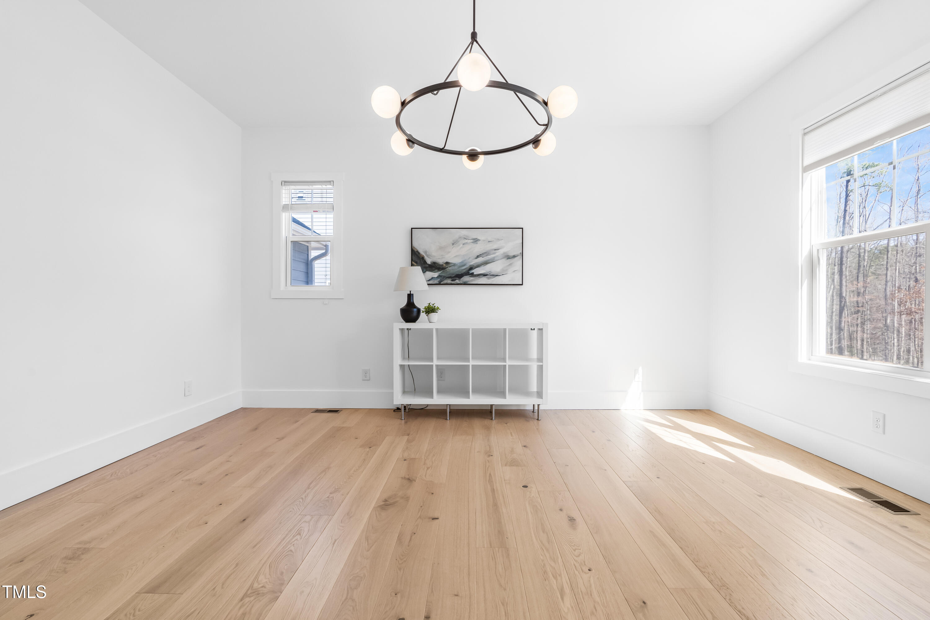 409 Tintern Lane Apex, NC 27523 - Photo 19 of 62 a view of empty room with wooden floor and fan