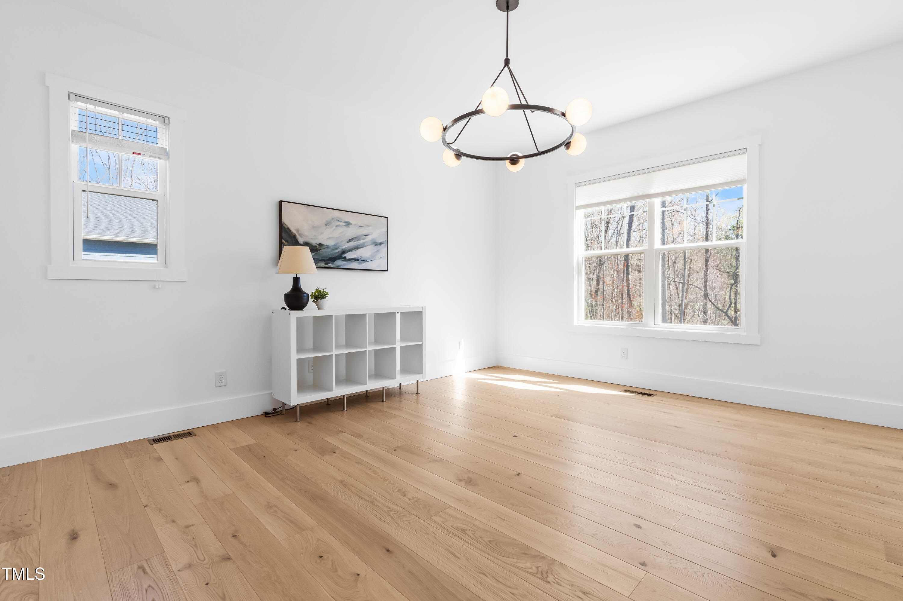 409 Tintern Lane Apex, NC 27523 - Photo 20 of 62 a view of an empty room with window and wooden floor