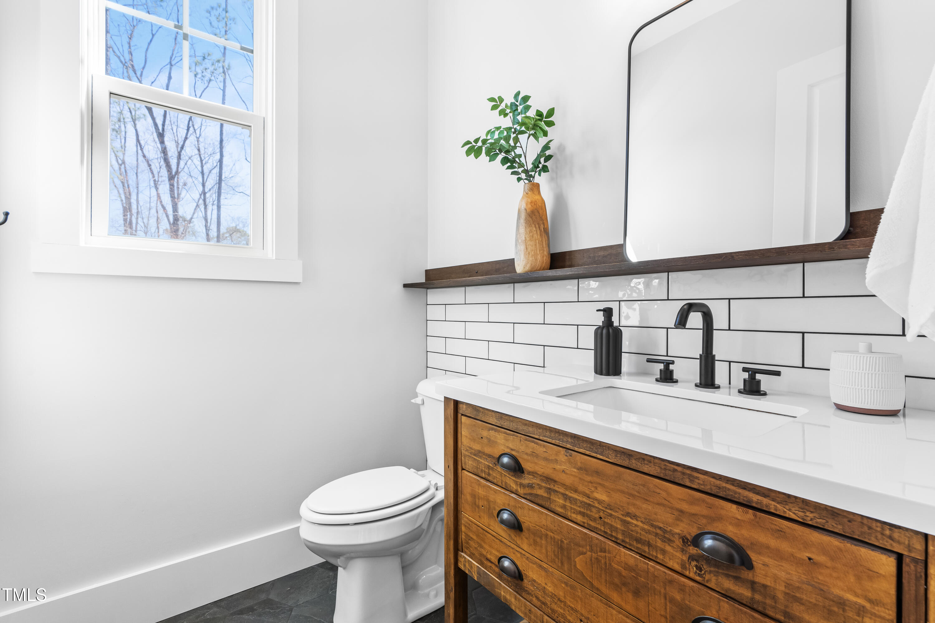 409 Tintern Lane Apex, NC 27523 - Photo 21 of 62 a bathroom with a granite countertop toilet sink and mirror