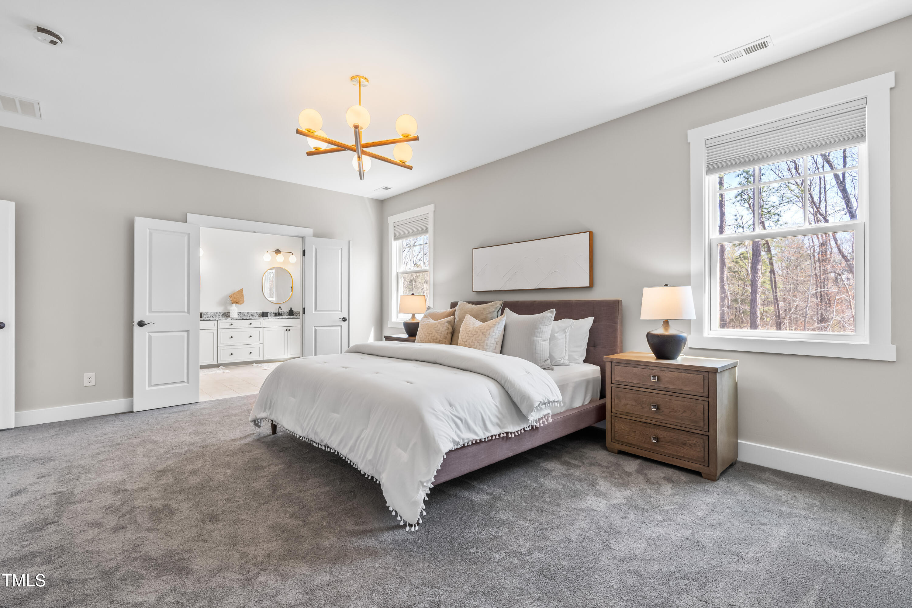409 Tintern Lane Apex, NC 27523 - Photo 26 of 62 a spacious bedroom with a bed chandelier and window