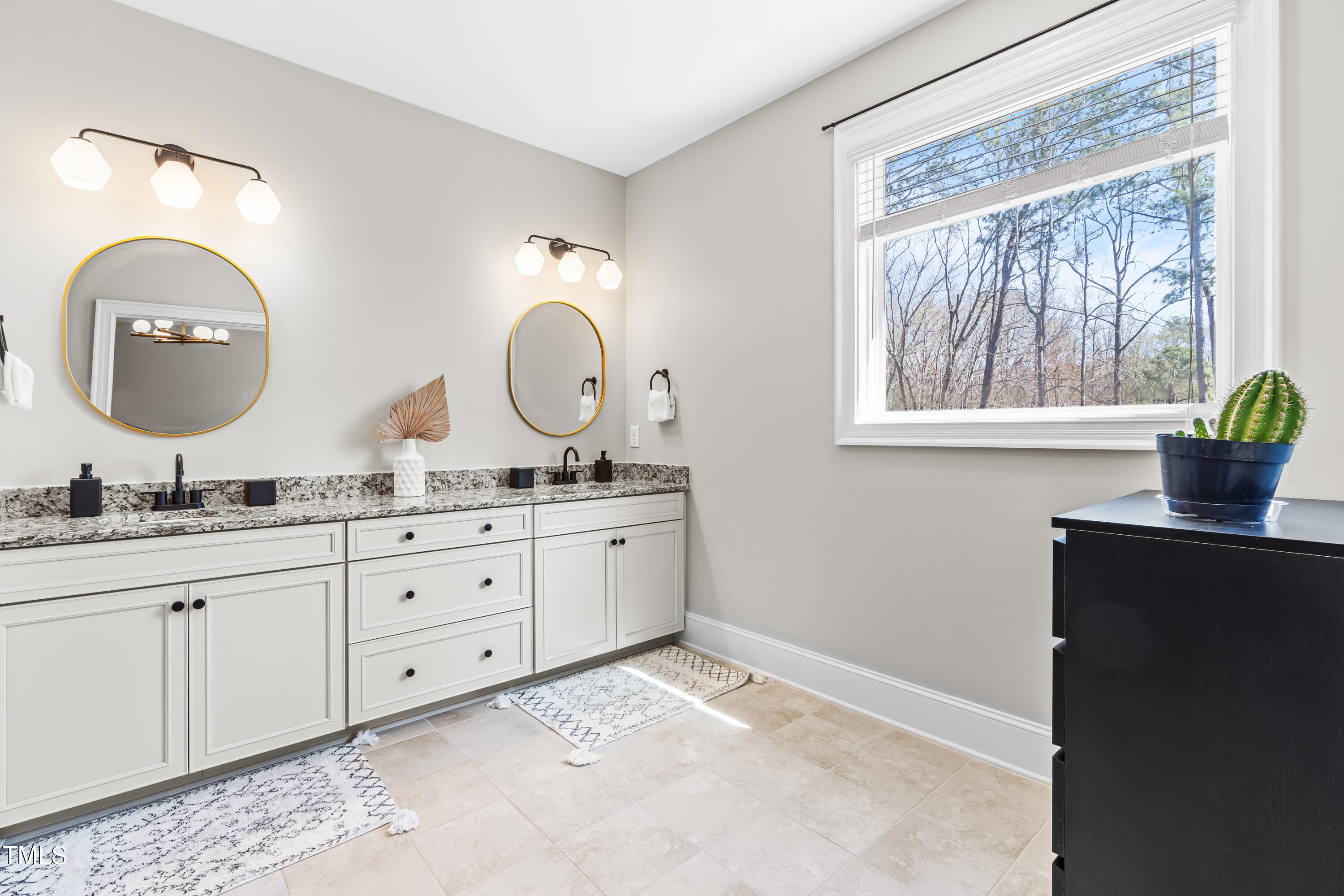 409 Tintern Lane Apex, NC 27523 - Photo 31 of 62 a bathroom with a granite countertop double vanity and a mirror
