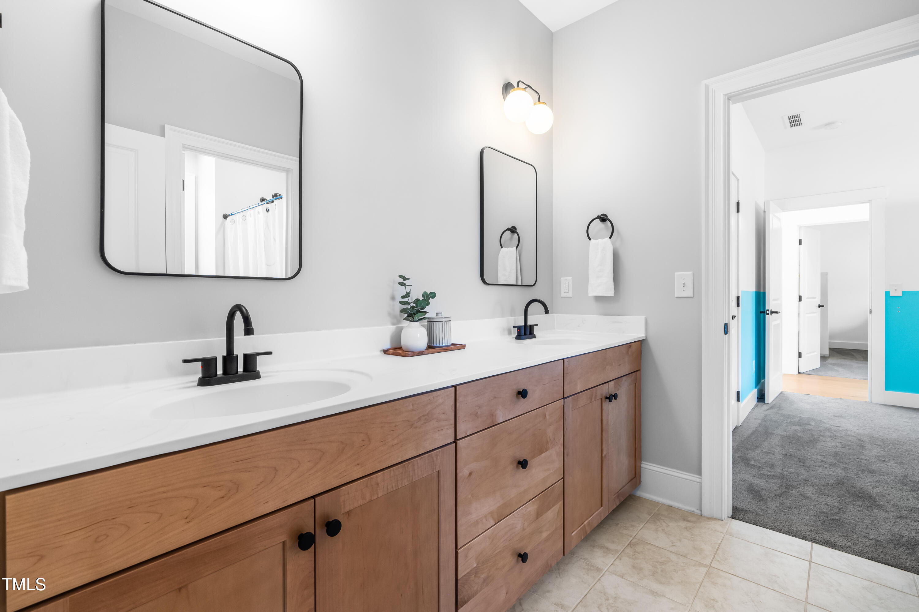 409 Tintern Lane Apex, NC 27523 - Photo 38 of 62 a bathroom with a double vanity sink mirror and