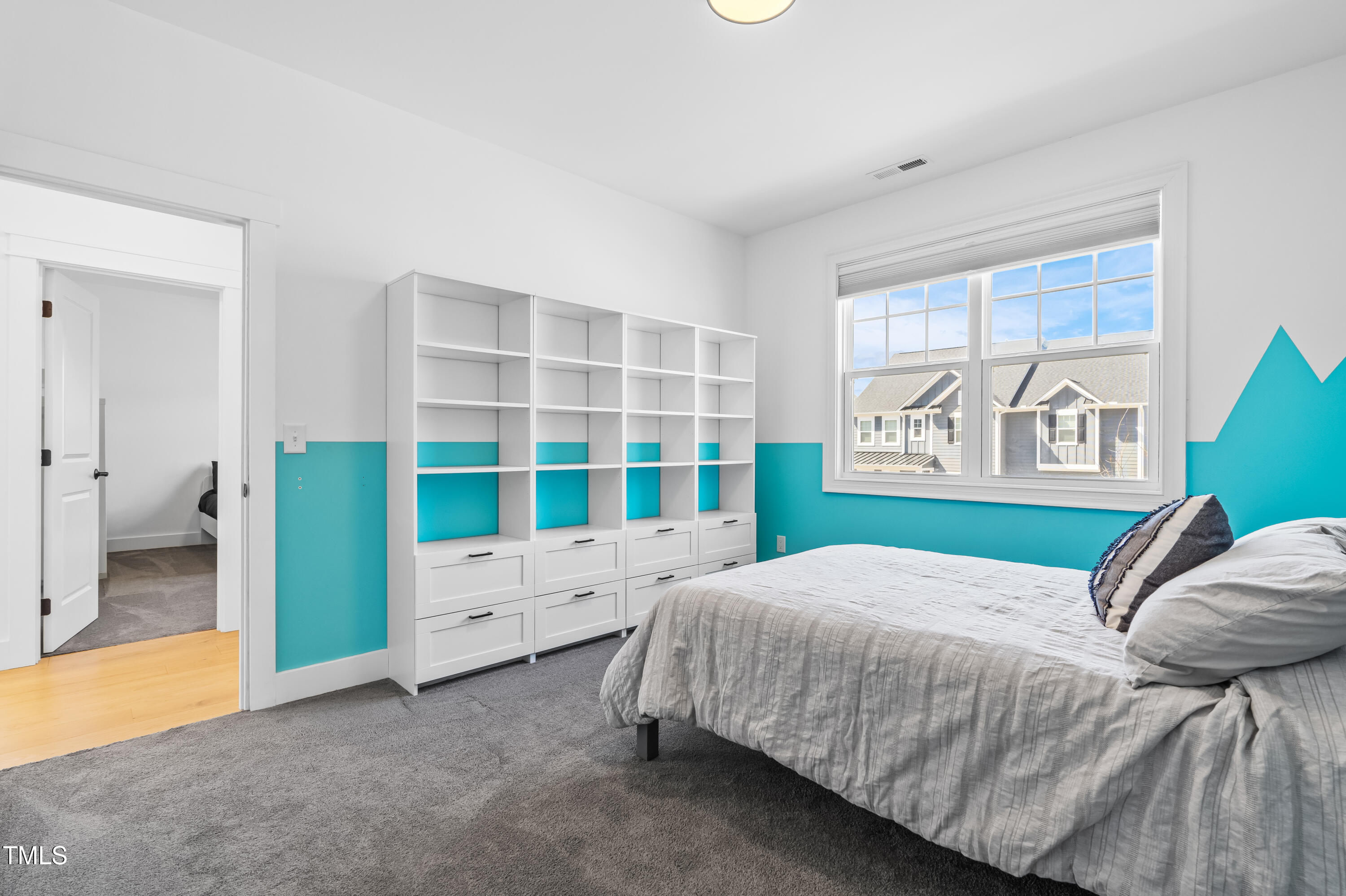 409 Tintern Lane Apex, NC 27523 - Photo 40 of 62 a bedroom with a bed and a large window