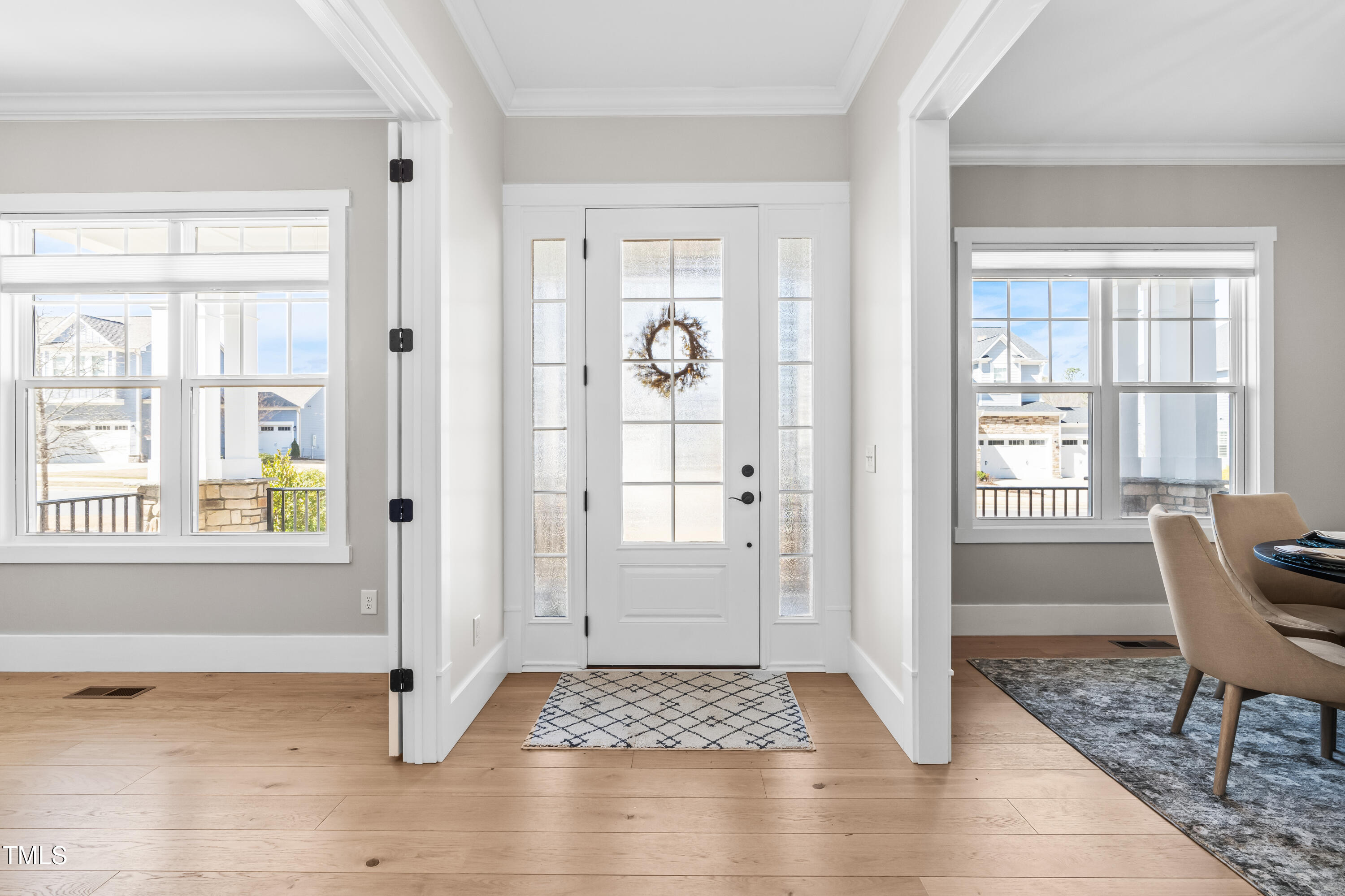 409 Tintern Lane Apex, NC 27523 - Photo 4 of 62 a view of a livingroom with wooden floor and a window