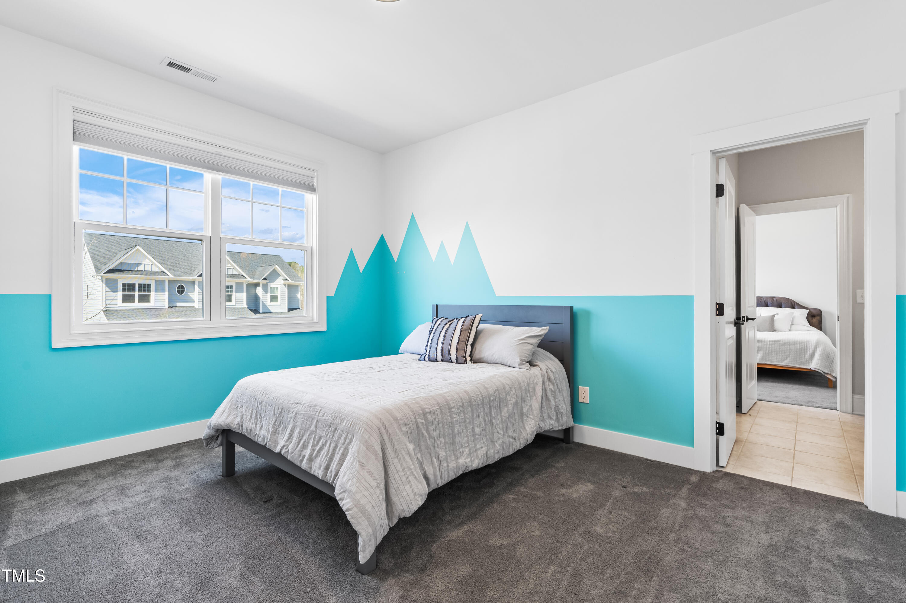 409 Tintern Lane Apex, NC 27523 - Photo 41 of 62 a bedroom with a bed and a painting on the wall