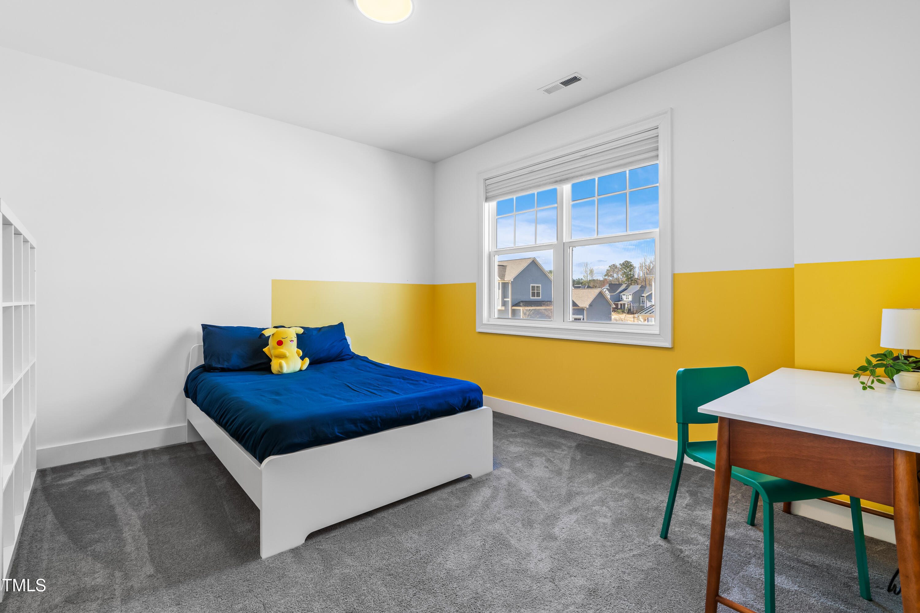 409 Tintern Lane Apex, NC 27523 - Photo 42 of 62 a bedroom with a bed and a table in it