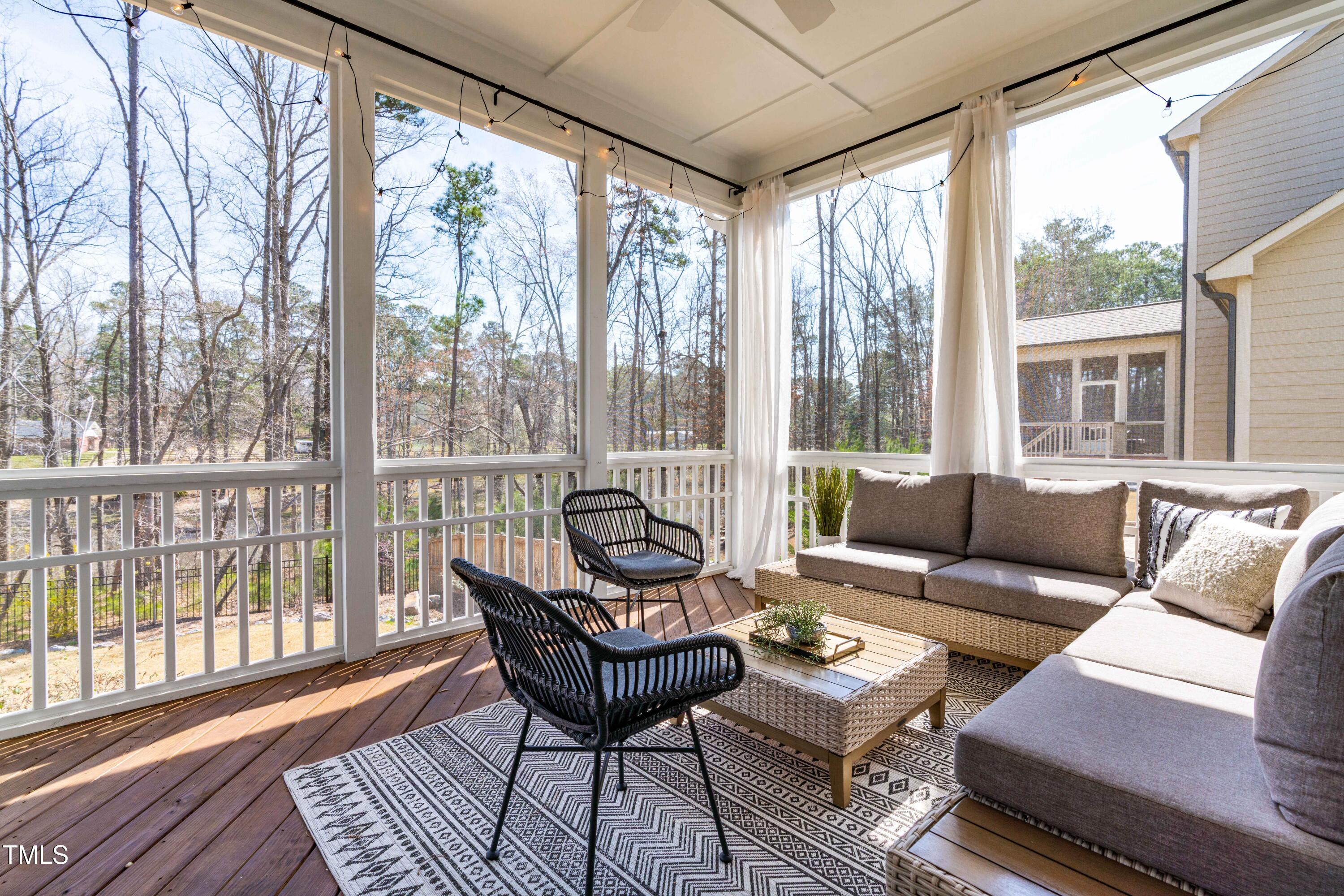 409 Tintern Lane Apex, NC 27523 - Photo 48 of 62 a living room with furniture and a floor to ceiling window