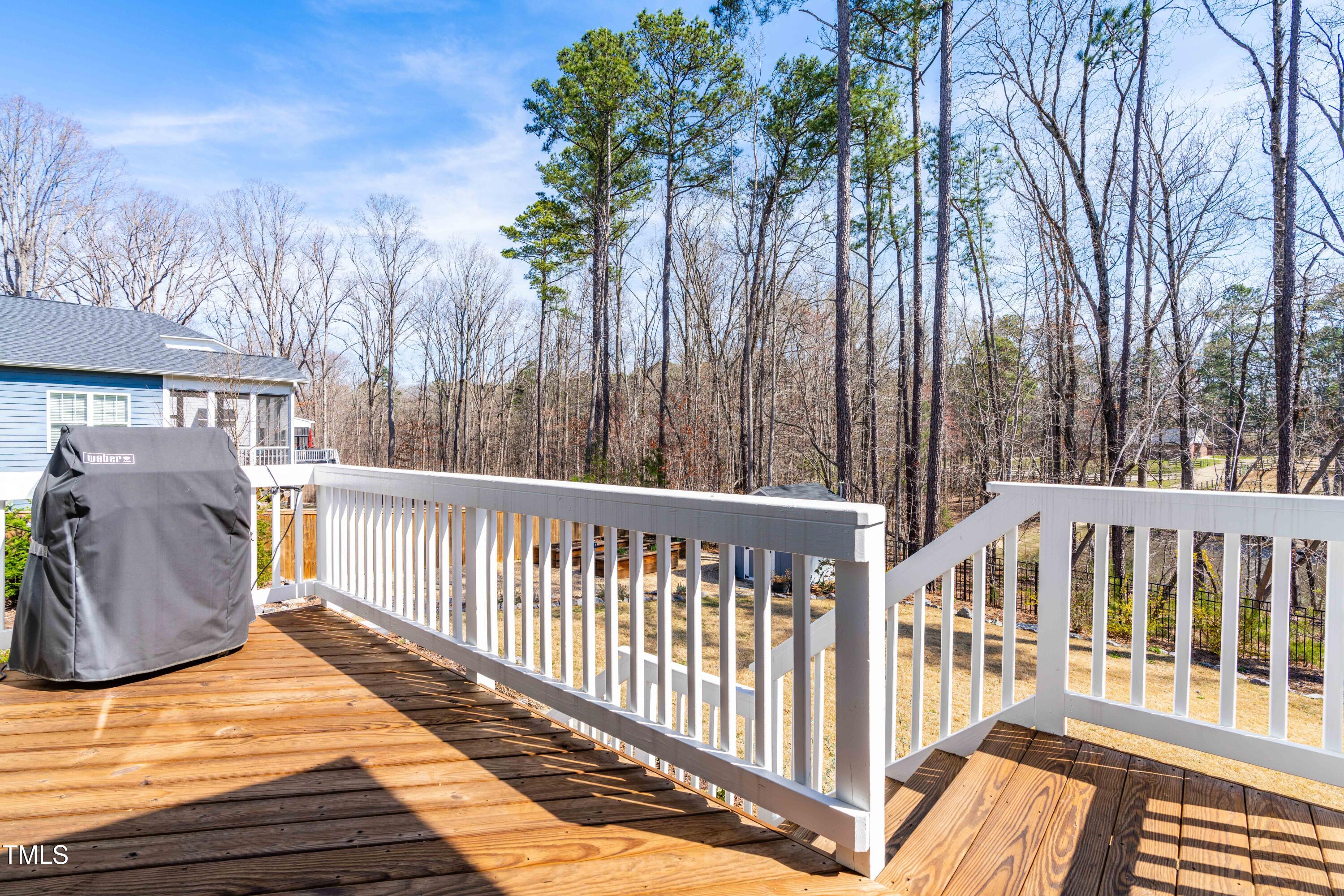 409 Tintern Lane Apex, NC 27523 - Photo 50 of 62 a view of a wooden deck with chairs and wooden floor