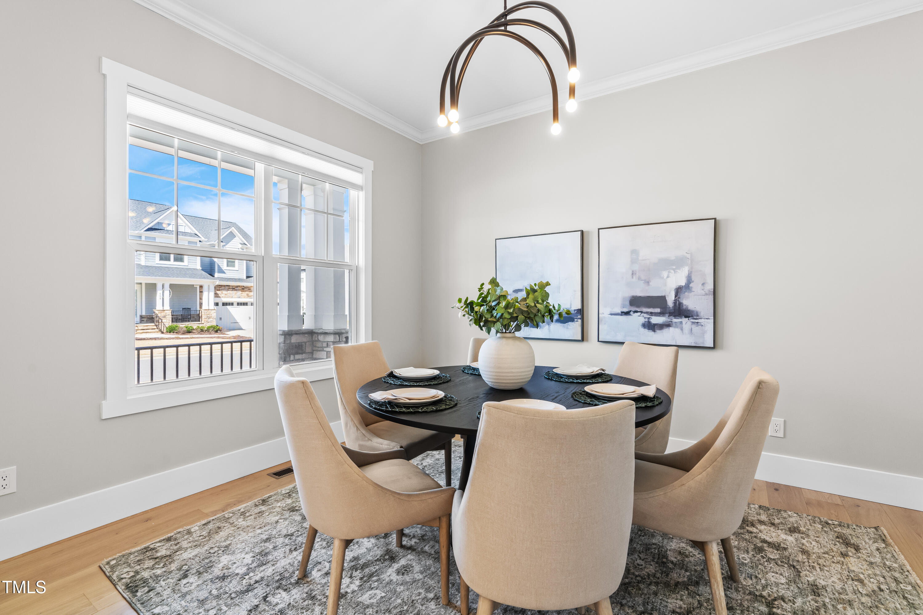 409 Tintern Lane Apex, NC 27523 - Photo 5 of 62 a dining room with furniture a window and wooden floor
