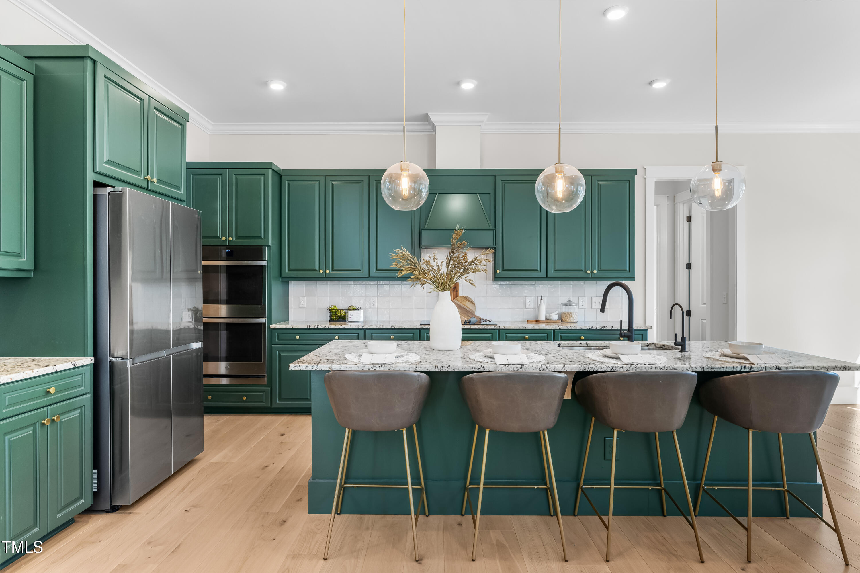 409 Tintern Lane Apex, NC 27523 - Photo 6 of 62 a kitchen with a refrigerator a sink and chairs