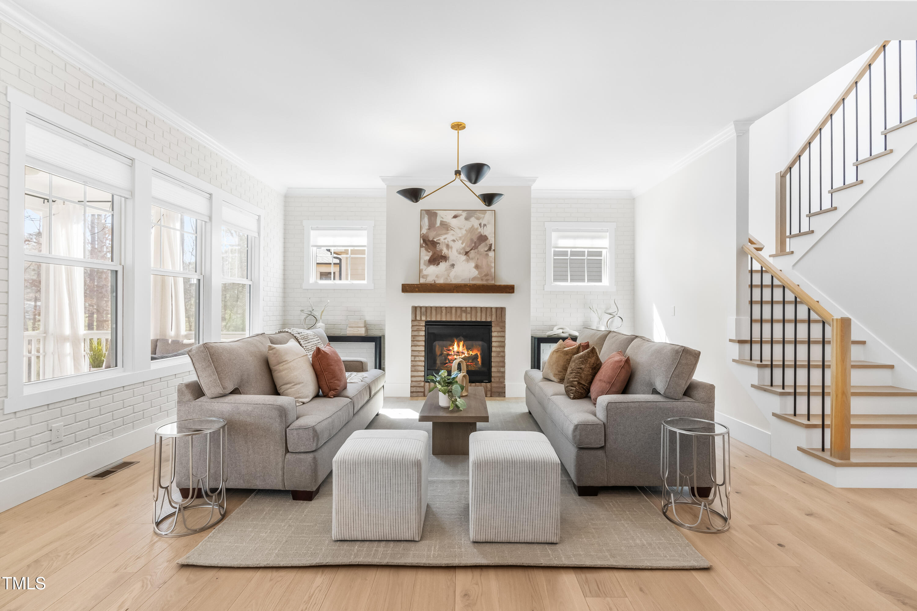 409 Tintern Lane Apex, NC 27523 - Photo 7 of 62 a living room with furniture and a fireplace
