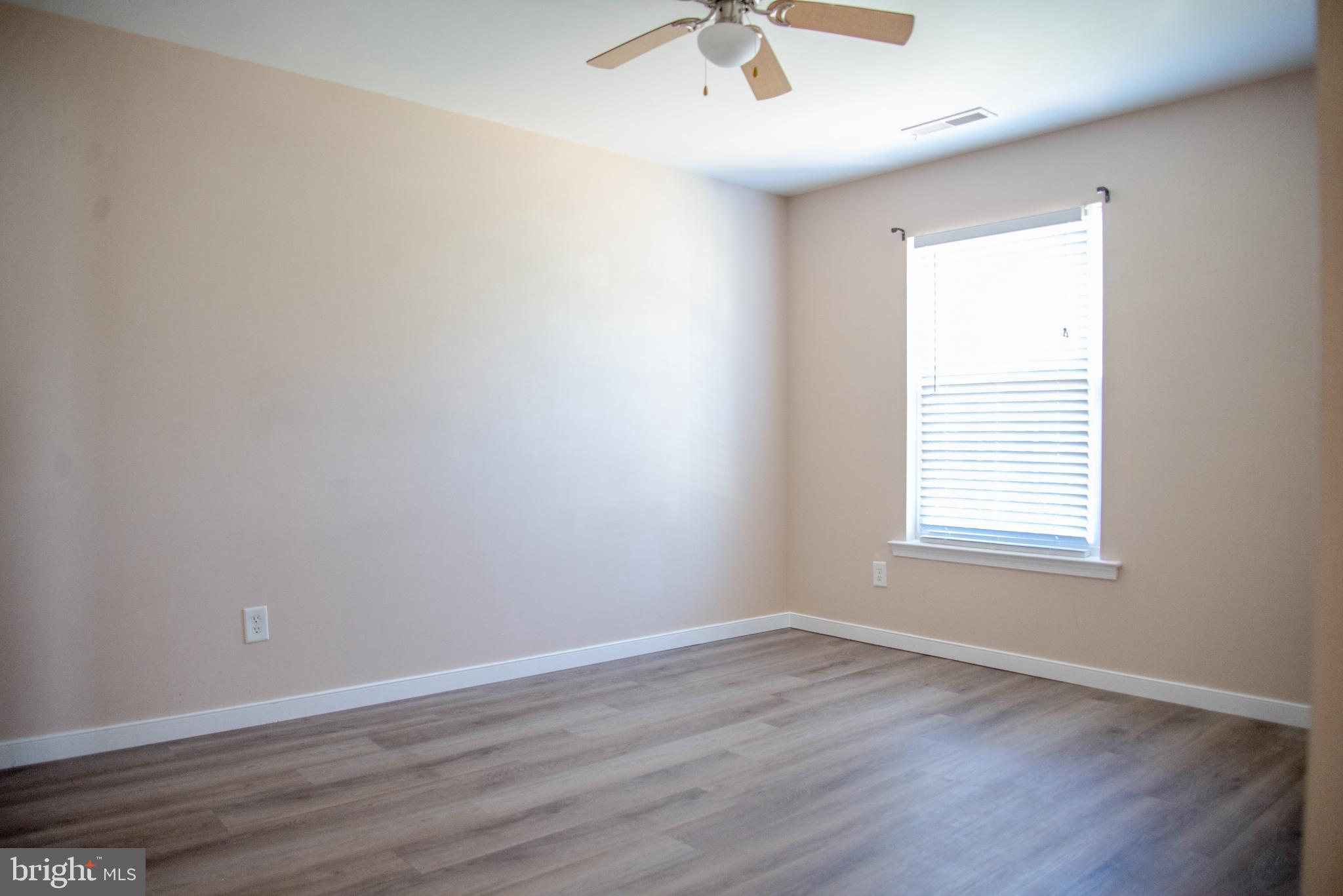15212 Fairen Lane Colonial Heights, VA 23834 - Photo 22 of 31 an empty room with wooden floor and windows