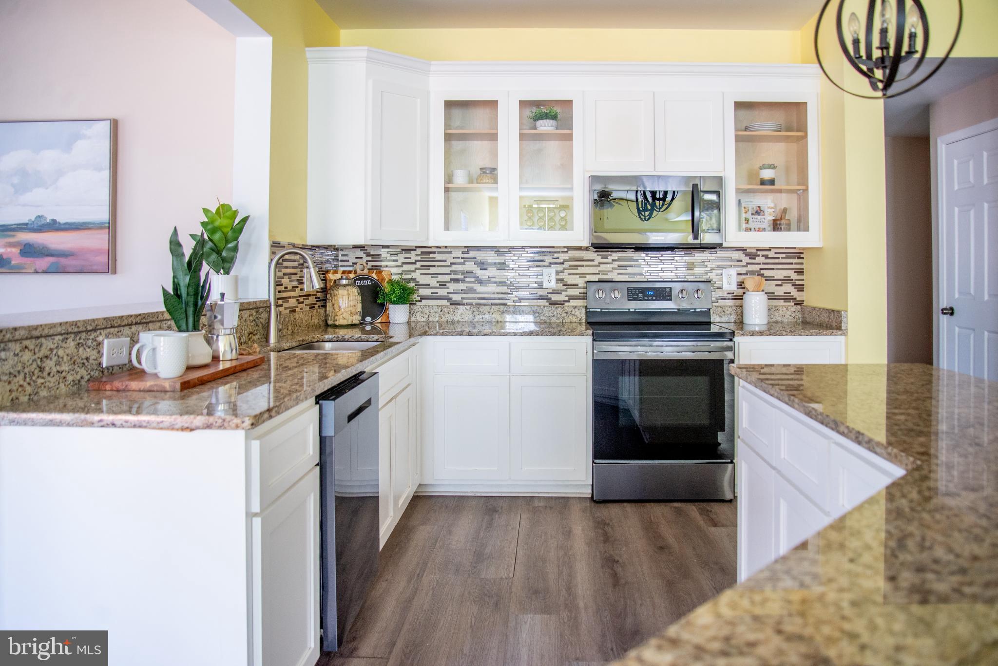 15212 Fairen Lane Colonial Heights, VA 23834 - Photo 9 of 31 a kitchen with stainless steel appliances granite countertop a sink a stove a microwave a sink and a refrigerator