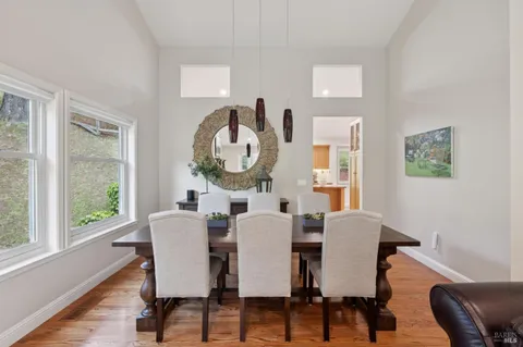 a view of a dining room with furniture window and wooden floor