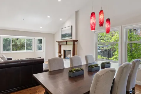 a living room with furniture fireplace and a large window