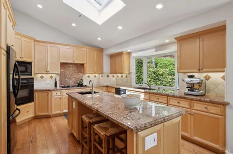 a kitchen with a sink a stove and cabinets