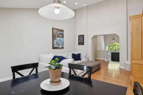 a living room with furniture and kitchen view