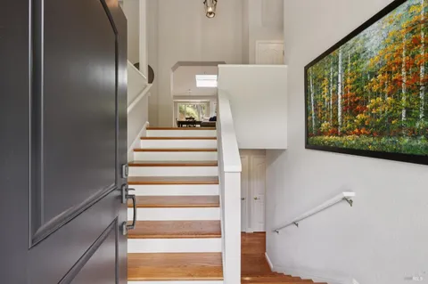 a view of entryway with wooden floor and front door