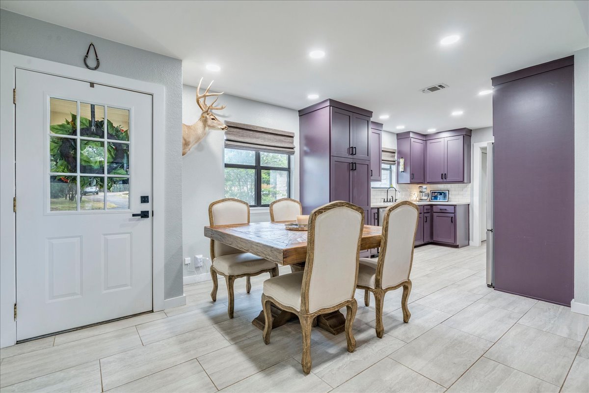 104 Clear Springs Road Georgetown, TX 78628 - Photo 3 of 30 This combined kitchen and dining area features recessed lighting and stylish cabinetry.