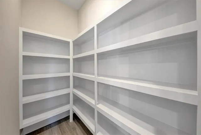 a view of walk in closet with empty racks
