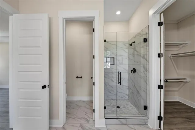 a bathroom with a glass shower door and a sink