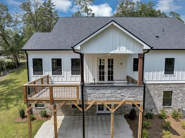 a view of a house with a yard porch and furniture