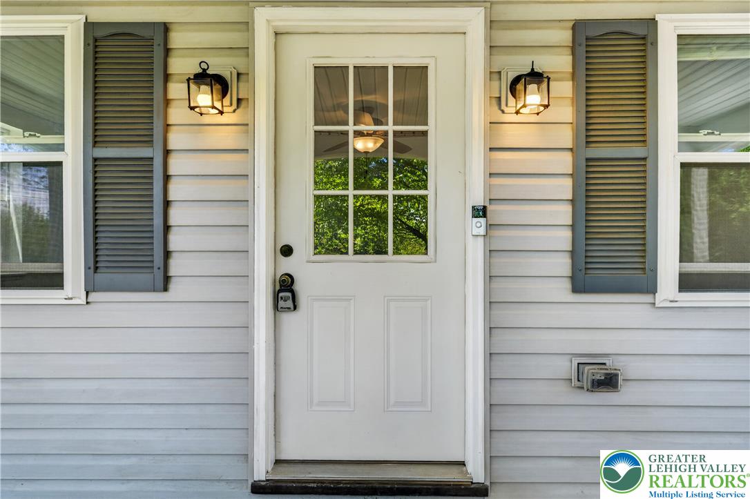 1411 Lieb Road Easton, PA 18040 - Photo 12 of 46 A classic white front door with glass panels welcomes you home, flanked by charming exterior light fixtures.