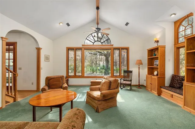 a bedroom with a bed and a dresser with wooden floor