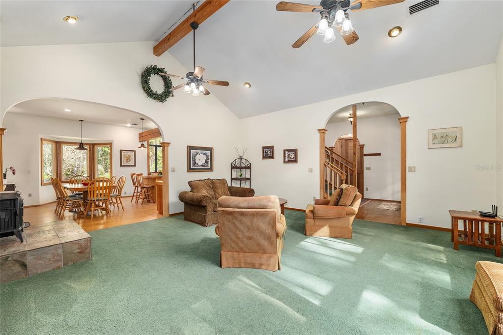 21736 Northwest 75th Avenue Road Micanopy, FL 32667 - Photo 21 of 88 a living room with furniture and a large window
