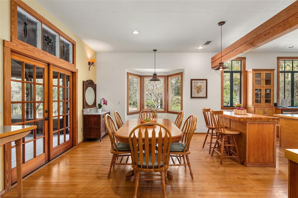 21736 Northwest 75th Avenue Road Micanopy, FL 32667 - Photo 24 of 88 a view of a dining room with furniture window and wooden floor