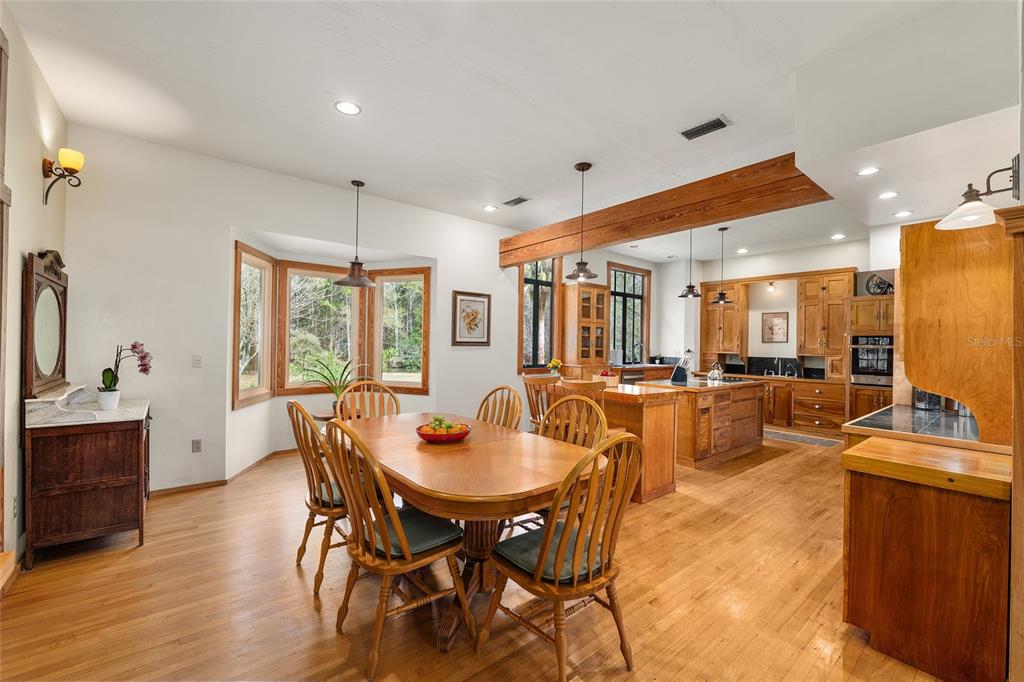 21736 Northwest 75th Avenue Road Micanopy, FL 32667 - Photo 25 of 88 a dining room with furniture and wooden floor