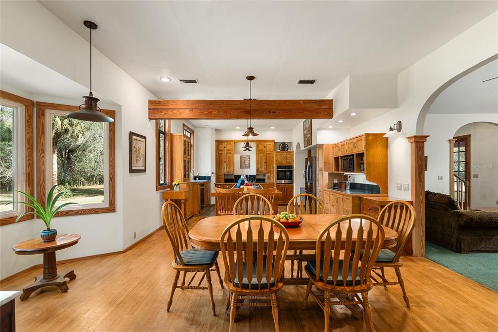 21736 Northwest 75th Avenue Road Micanopy, FL 32667 - Photo 26 of 88 a view of a dining room with furniture window and outside view
