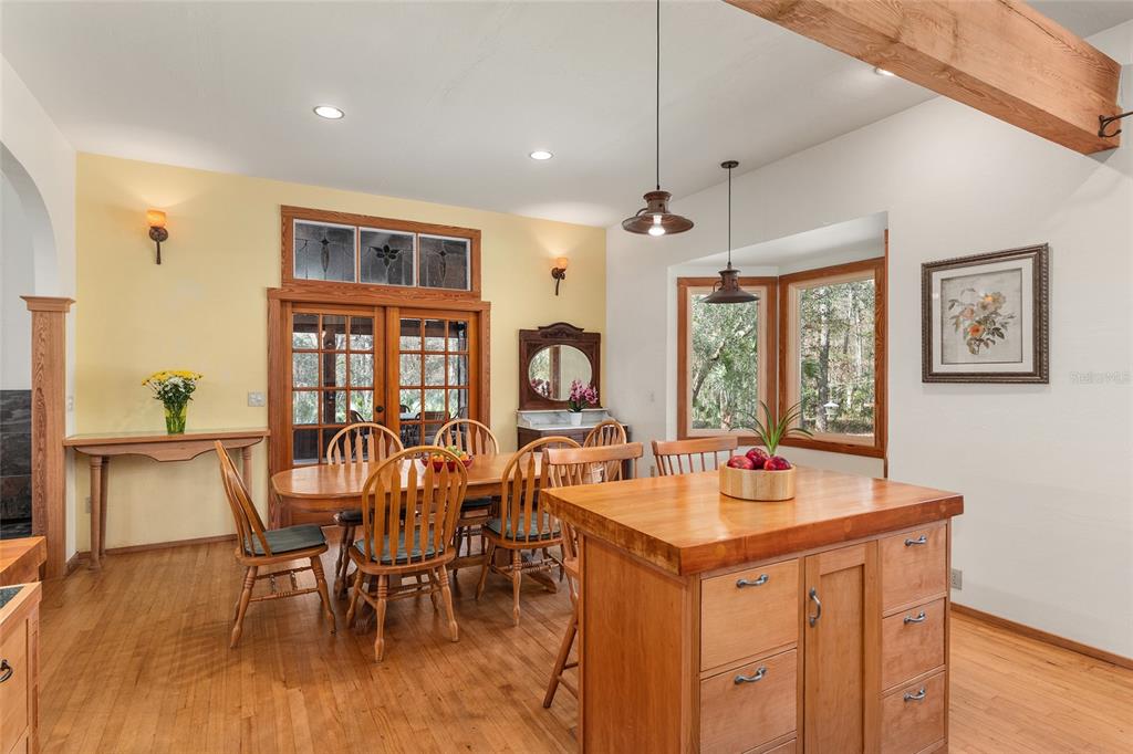 21736 Northwest 75th Avenue Road Micanopy, FL 32667 - Photo 29 of 88 a view of a dining room with furniture window and wooden floor