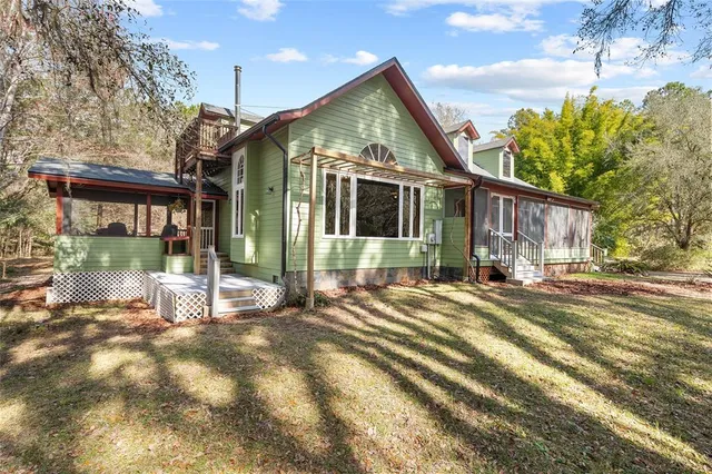 a living room with furniture a clock and a large window