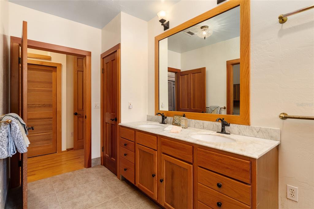 21736 Northwest 75th Avenue Road Micanopy, FL 32667 - Photo 45 of 88 a bathroom with a double vanity sink and mirror