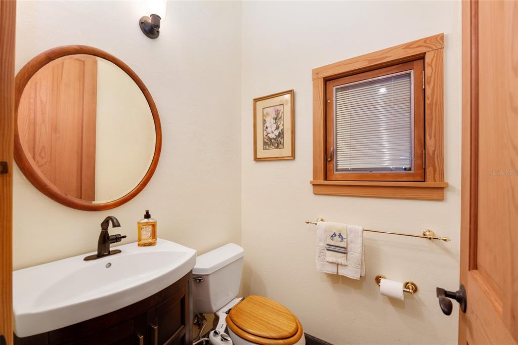 21736 Northwest 75th Avenue Road Micanopy, FL 32667 - Photo 50 of 88 a bathroom with a sink a toilet and a mirror