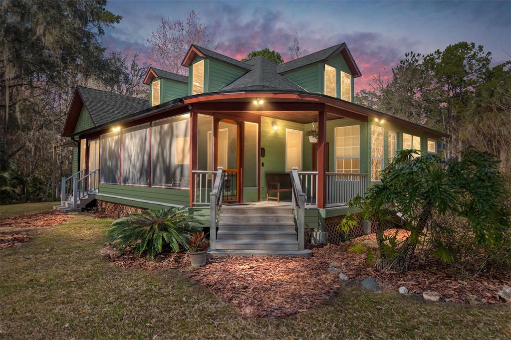 21736 Northwest 75th Avenue Road Micanopy, FL 32667 - Photo 5 of 88 a view of a house with a small yard plants and large tree