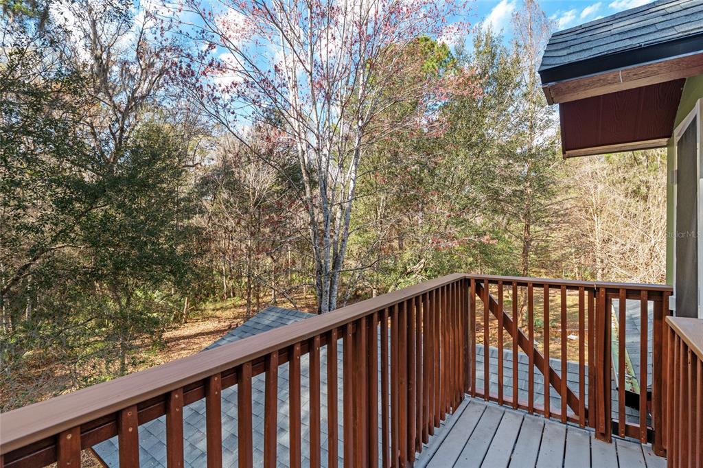 21736 Northwest 75th Avenue Road Micanopy, FL 32667 - Photo 58 of 88 a view of a balcony with wooden fence and floor
