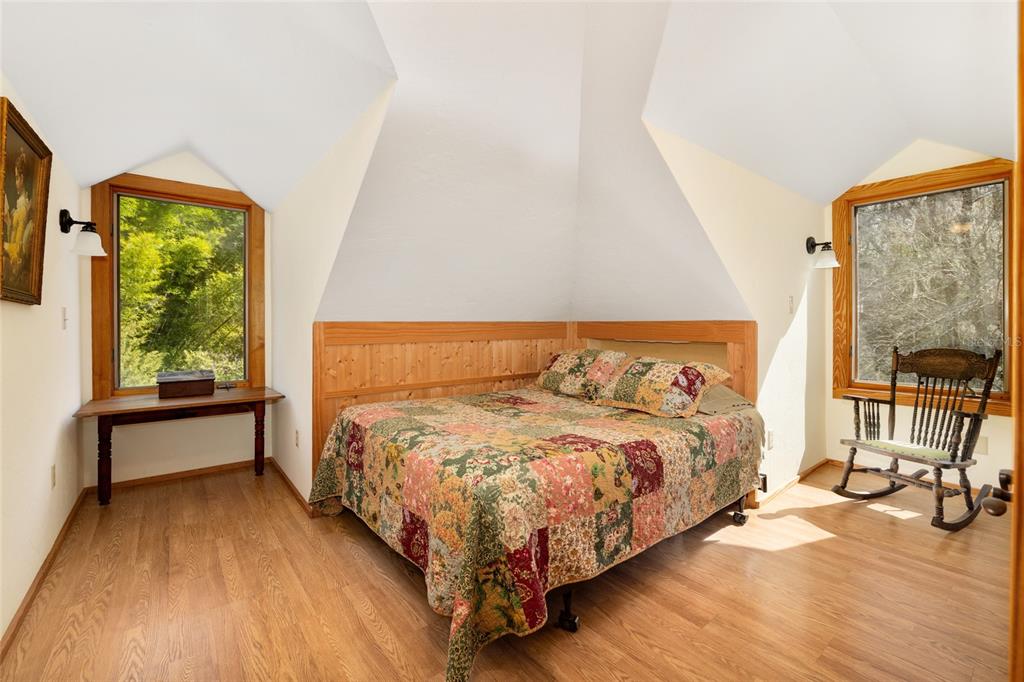 21736 Northwest 75th Avenue Road Micanopy, FL 32667 - Photo 59 of 88 a bedroom with a bed and a large window