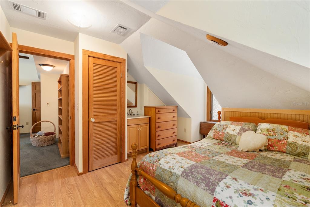 21736 Northwest 75th Avenue Road Micanopy, FL 32667 - Photo 62 of 88 a bedroom with a bed and a walk in closet