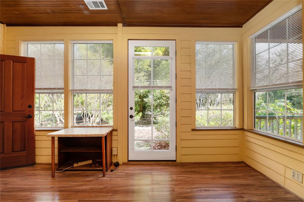 21736 Northwest 75th Avenue Road Micanopy, FL 32667 - Photo 71 of 88 a view of empty room with wooden floor and fan