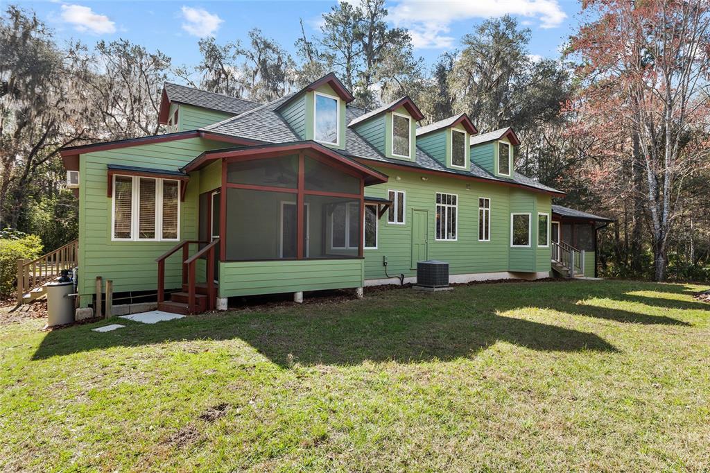 21736 Northwest 75th Avenue Road Micanopy, FL 32667 - Photo 75 of 88 a front view of a house with a garden