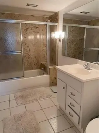 a bathroom with a shower sink and mirror