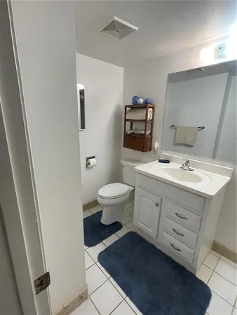a bathroom with a double vanity sink toilet and mirror