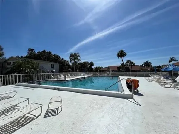 a view of swimming pool with outdoor seating and city view