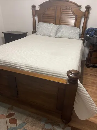 a bedroom with a bed and a dresser
