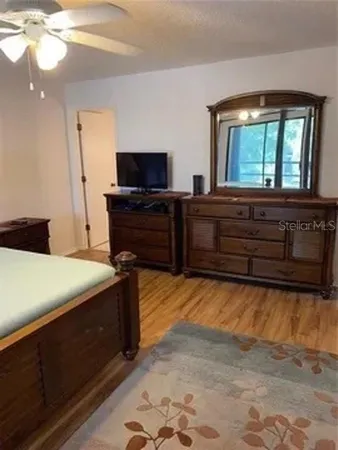 a bedroom with a bed and a television
