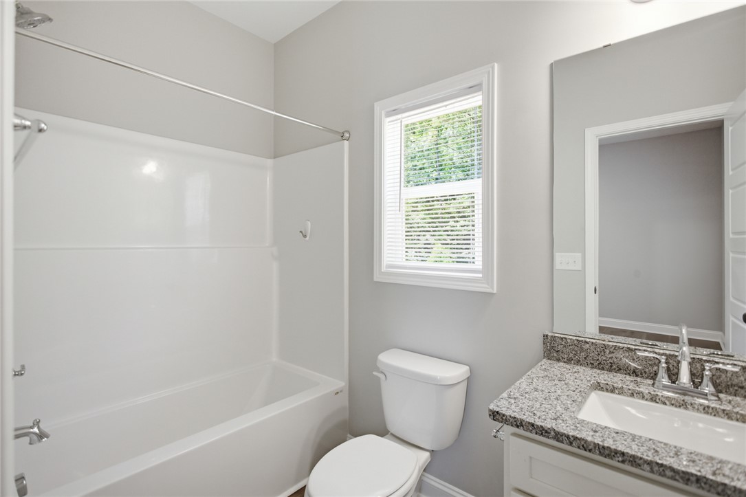 912 Watercrest Road West Union, SC 29696 - Photo 26 of 49 This bright bathroom features a spacious tub and a practical vanity with ample counter space.