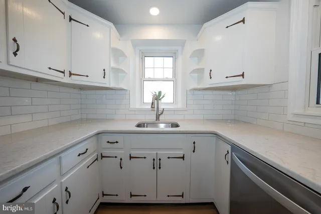 a view with cabinets a sink and dishwasher in a kitchen